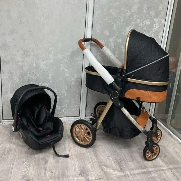 A stylish 3-in-1 premium baby stroller in black and gold, featuring a quilted design, adjustable handlebar, and durable wheels. Includes a detachable infant car seat for versatile use. Perfect for comfort, safety, and convenience.