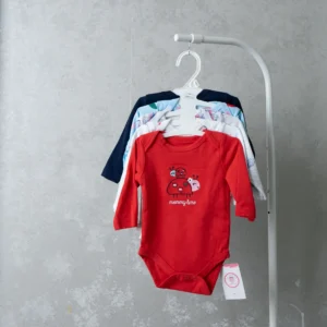 A set of pastel-colored baby bodysuits hanging on a white hanger, with the front onesie in soft pink adorned with a small floral design.