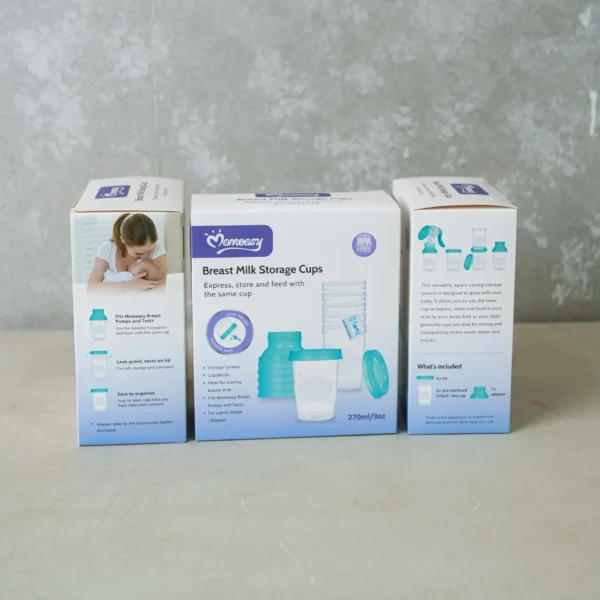 A box set of Momeasy Breast Milk Storage Cups displayed on a light surface, showing the front and side packaging. The product includes BPA-free 270ml/9oz storage cups with leak-proof lids, designed for expressing, storing, and feeding breast milk using the same cup. The sides highlight features and compatibility with Momeasy breast pumps and teats.