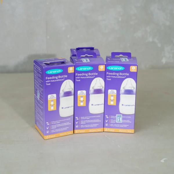 Three purple-packaged Lansinoh Feeding Bottles with NaturalWave® Teat, each holding 160ml (5oz). The packaging highlights features such as easy switching from breast to bottle, a soft and flexible teat for natural feeding, and an anti-colic air ventilation system (AVS) to reduce gas and discomfort.
