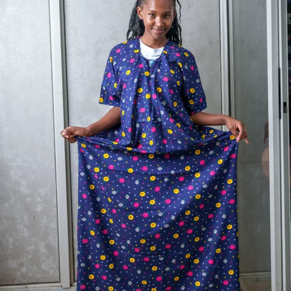 Woman modeling a navy blue nursing dera featuring a colorful floral print, highlighting the garment’s modest coverage and relaxed fit.